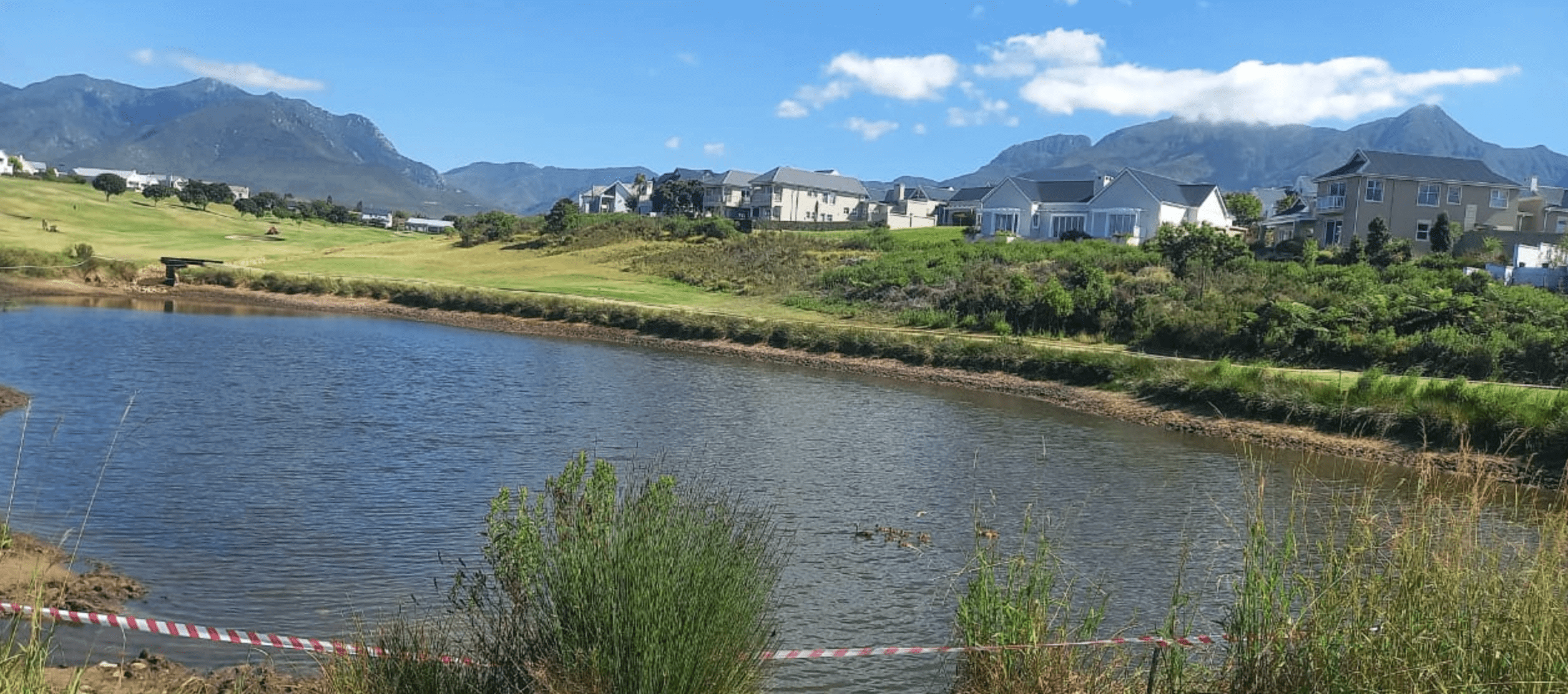 Danger tape warned homeowners and golfers to steer clear of the sludge