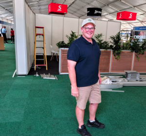 Guy Bower, the show’s de facto ‘chief ops guy’, wearing a genuine smile in the midst of the pr-opening chaos, which typifies any large event. Guy Bower, the show’s de facto ‘chief ops guy’, wearing a genuine smile in the midst of the pr-opening chaos, which typifies any large event.